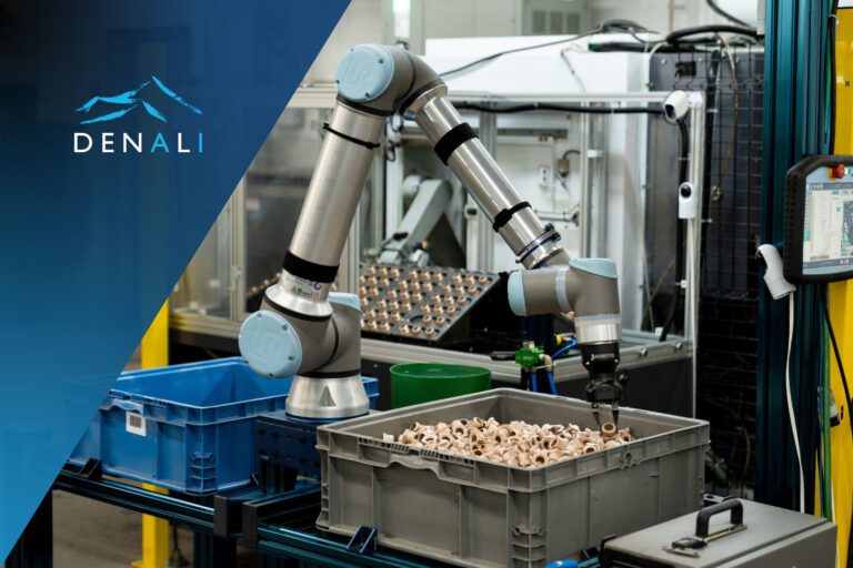 A robotic arm sorting parts as part of a manufacturing automation partnership between Denali and Universal Robots.